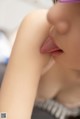 A close up of a woman sticking out her tongue.