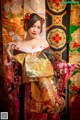 A woman in a kimono poses for a picture. 