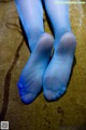 A pair of blue tights sitting on top of a bed.